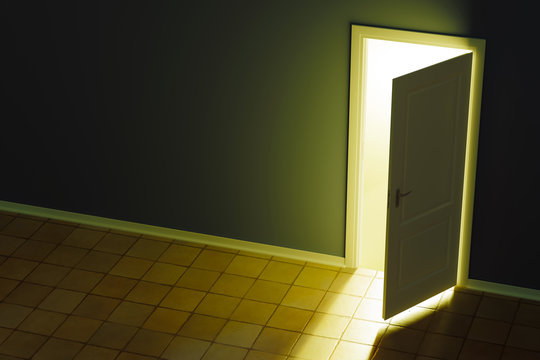 ajar door and light through it into a dark room.
