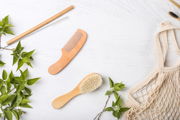 Set of Eco friendly bamboo combs on wooden backing. ECO brush. Sustainable lifestyle. Plastic free concept. Top view, flat lay, mockup