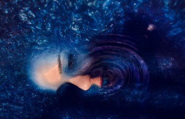 Model in colorful blue water like space. Deep color and texture. - obrazy, fototapety, plakaty