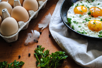 Breakfast with fried eggs, chicken eggs on the table.