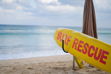 Yellow surf rescue board sea beach sign to protect and save people