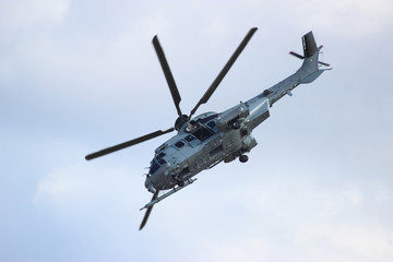 Naklejka na ściany i meble Military helicopter during the flight