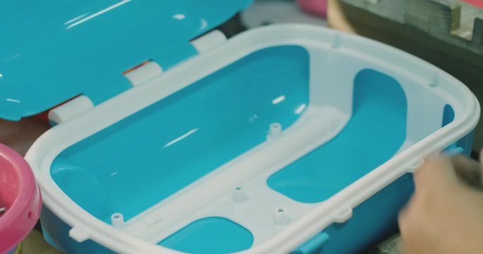 woman collects toys at the factory. closeup on hands. filmed on RED CINEMA