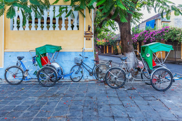 Fototapeta na wymiar Cyclo on a street of Hoi An old town,Quang Nam, Vietnam.