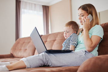 Busy mother on the phone and her bored son near