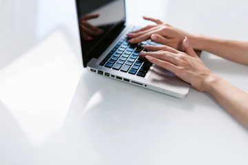 Young business woman is typing on laptop keyboard. Coronavirus. Quarantine. isolation, social distancing, freelance work from home office, self-isolation.