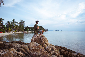 Fototapeta na wymiar Young man meditating on the beach