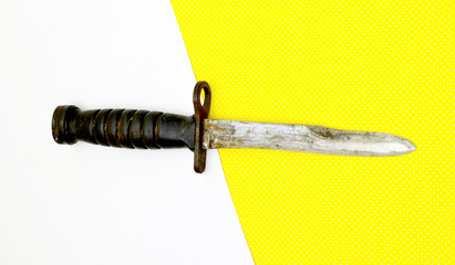 old bayonet on yellow white background isolated
