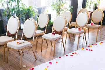 Creamy white wedding chairs in restaurant.