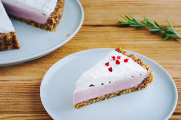 Fruit cake with nuts and cream, on a wooden background	