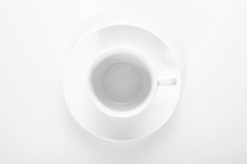 empty small white porcelain coffee Cup on a white saucer top view isolated on a white background