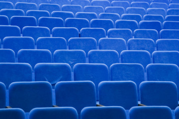 Blue empty seats in the hall are prepared for participants of mass events. Organization and holding of mass events, conferences or presentations