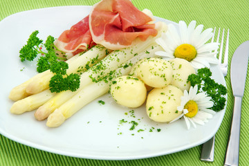White asparagus with potatoes and ham on plate, copy space
