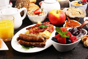Breakfast served with coffee, orange juice, croissants, cereals and fruits. Balanced diet. Continental breakfast with granola and fruits