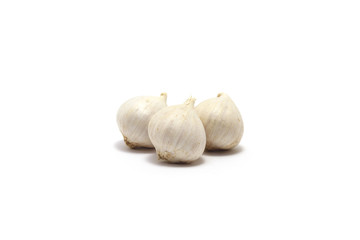 Three solo garlics isolated on white background