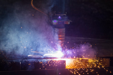 Fototapeta na wymiar Plasma gas cutting machine, cuts into the metal surface of the workpiece for parts.