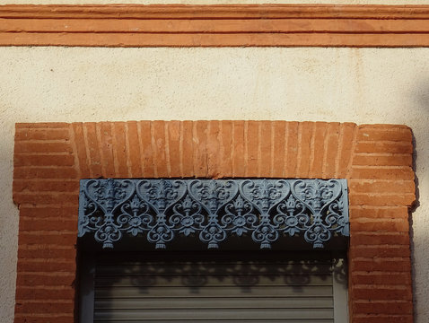 Detail of window with beautiful smelting metallic dossal in the city Toulouse. France. 