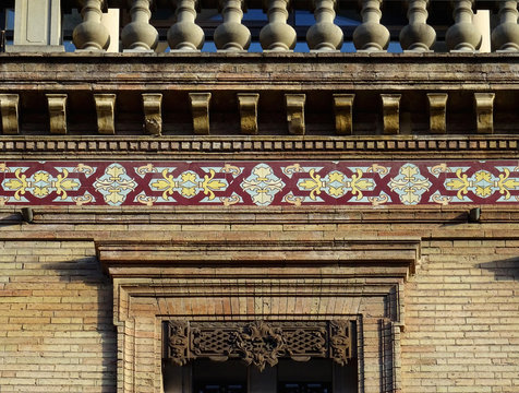 Detail of window with beautiful smelting metallic dossal and cornice with tiles. City Toulouse. France. 