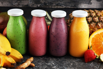 Assortment of fruit smoothies in glass bottles. Fresh organic Smoothie ingredients. Smoothies for...