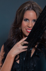 Portrait of a beautiful dancing woman on dark background with lights