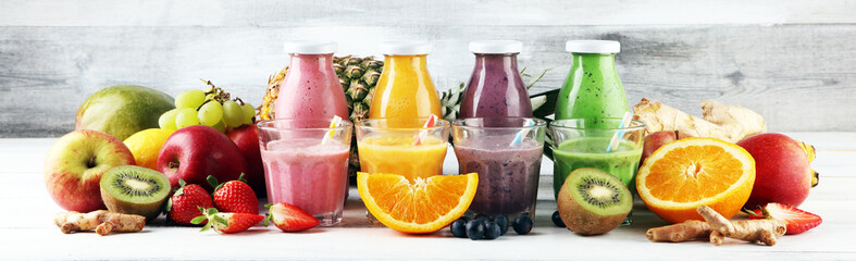 Assortment of fruit smoothies in glass bottles. Fresh organic Smoothie ingredients. Smoothies for...