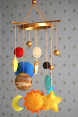 baby mobile over the bed in the form of space bodies