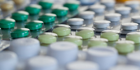 blisters with white, yellow and green tablets