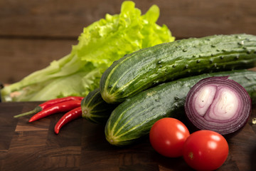 vegetables and greens on wooden cutting board