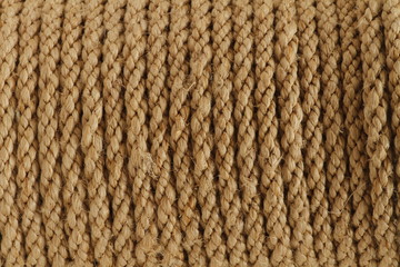 Rope background, texture, wallpaper, background. Half light beige round rope roll braid detail vintage style for industrial concept. Closeup of a thin hemp rope. Natural material. Copy space for your 