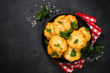 Chicken cutlet at dark table.