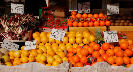 A display of citrus fruit on a street market stall
