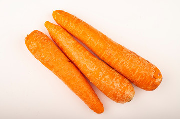 a few ripe carrots on a white background. Close up.