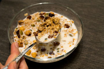 Healthy Breakfast, muesli with milk, nuts and dried fruits. Good nutrition.