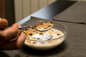 Healthy Breakfast, muesli with milk, nuts and dried fruits. Good nutrition.