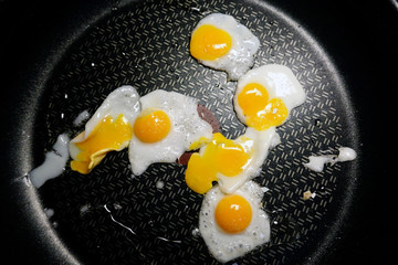 Quail eggs on frying pan. These small eggs are considered a delicacy in many parts of the world.