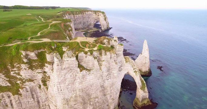 Cliffs of Etretat in Normandy, France. Clify white work of nature, photos from the drone, view of the rocks, beaches, green fields, sea and sun shot in the early season, summer, footage 4k25ftp