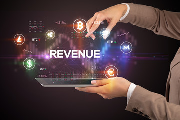 Close-up of a touchscreen with REVENUE inscription, business opportunity concept