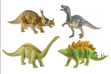 Four toy rubber dinosaurs isolated on white