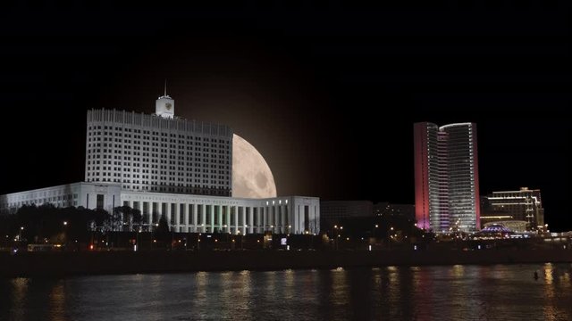 Full moon on the background of the House of Government in Moscow Time Lapse.