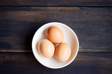 Brown eggs with wooden background
