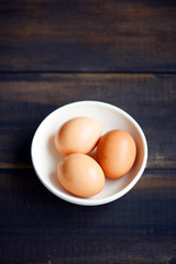 Brown eggs with wooden background