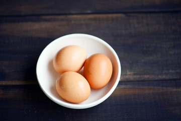 Brown eggs with wooden background