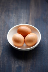 Brown eggs with wooden background