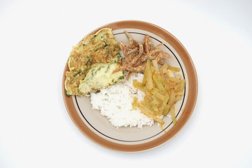 Generic common Indonesia meal with rice, salted fish, scramble egg, and chayote