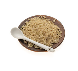 golden rice in a ceramic bowl with a white spoon on a white background