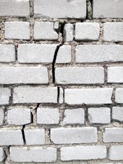 cracked old gray brick wall