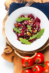 Healthy Vegetarian summer food concept Homemade vegan beetroot and rocket salad in white ceramic plate with copy space