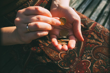 A woman counting money in the palm of her hand. © Dumitru