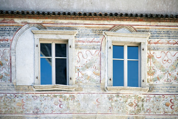 Italian windows on the beautiful pattern wall facade without shutters
