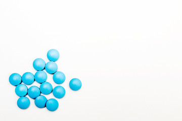 Blue pills on a white background. Space for text. Concept for medical news.